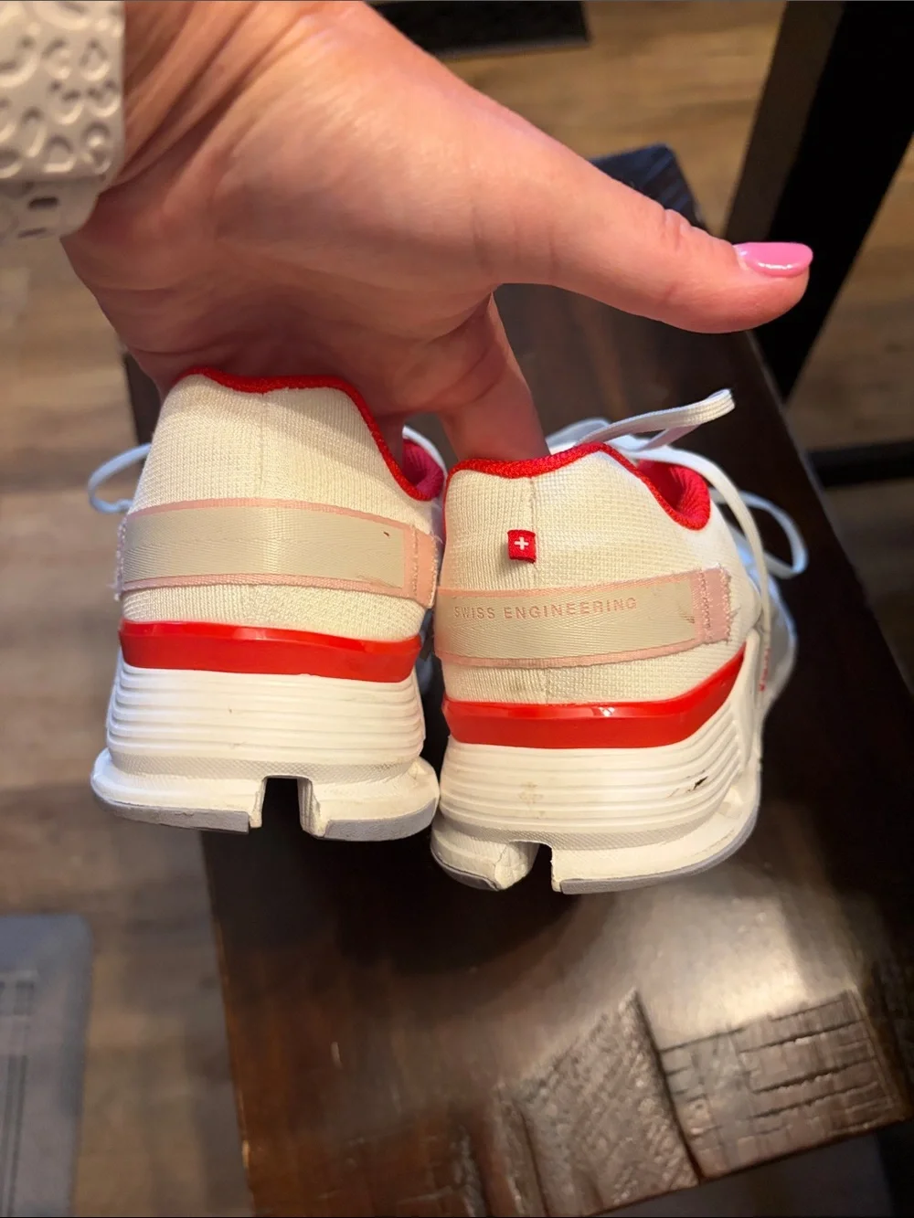 On Running White Athletic Shoes with Pink and Red Accents